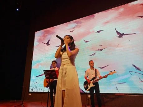 Singer and musicians at a PORTMAN performance