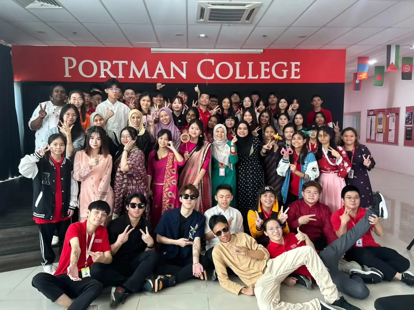 PORTMAN College community gathered beneath the College sign